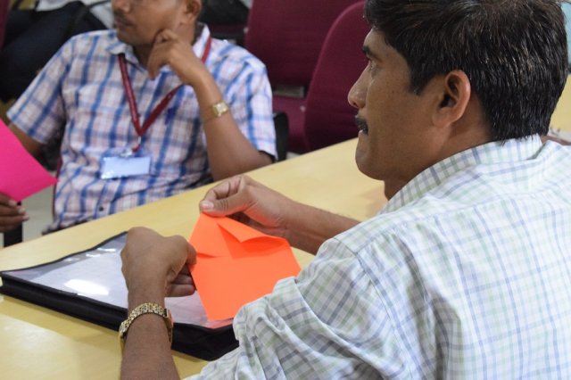Teachers trying their hands in Origami.
